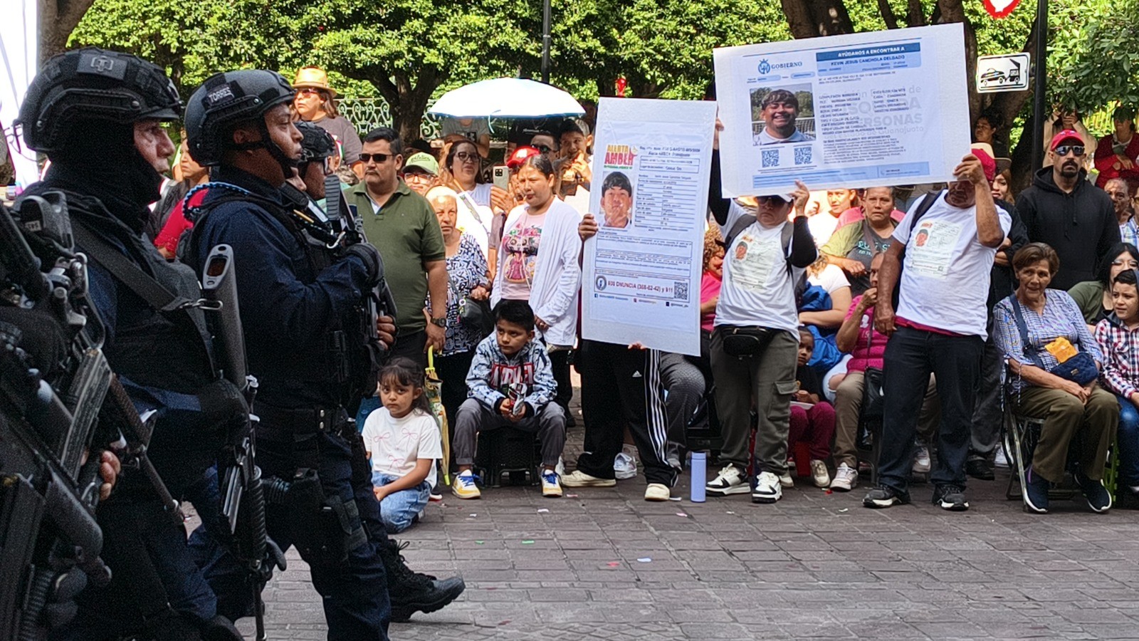 Exhiben fichas de búsqueda de cuatro jóvenes durante desfile en Celaya